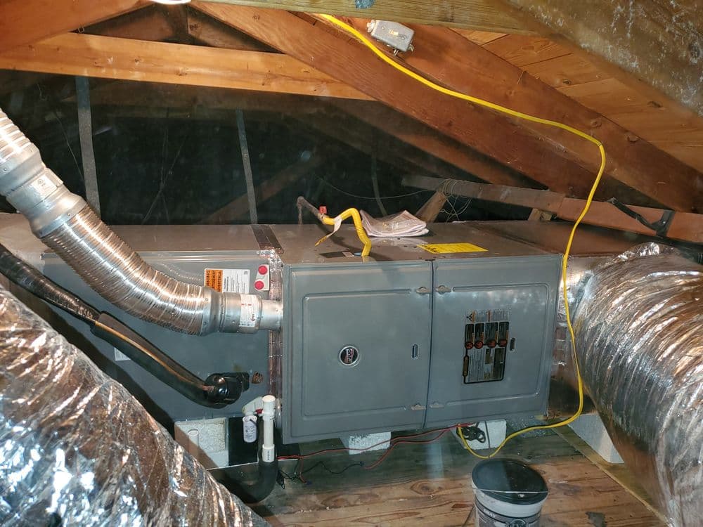 Home attic HVAC system with ducts, electrical panel, and insulation visible.